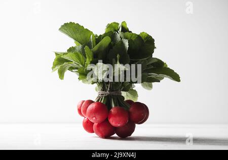 Bunch of fresh radishes on a white background Stock Photo