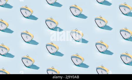Many vintage alarm clocks pattern on blue background Stock Photo