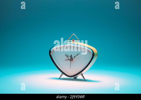 Retro alarm clock on a turquoise background Stock Photo