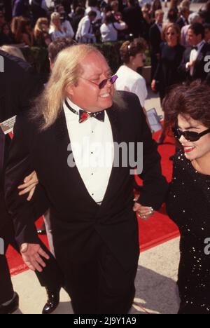 Sam Kinison and wife Malika Souiri at the 43rd Annual Primetime Emmy Awards on August 25, 1991 at the Pasadena Civic Auditorium in Pasadena, California.  Credit: Ralph Dominguez/MediaPunch Stock Photo