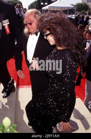 Sam Kinison and wife Malika Souiri at the 43rd Annual Primetime Emmy Awards on August 25, 1991 at the Pasadena Civic Auditorium in Pasadena, California.  Credit: Ralph Dominguez/MediaPunch Stock Photo