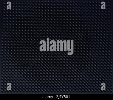 Black metal perforated background with round holes close up view Stock Photo