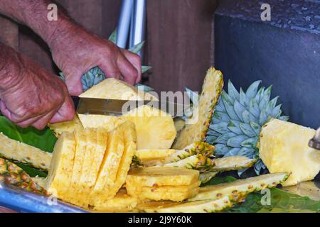 Pineapple cutting, Central America Stock Photo