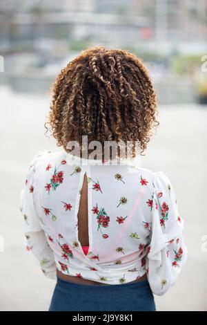 Rear view of black woman with curly hair Stock Photo