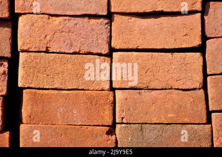 Pile of red bricks texture pattern background Stock Photo