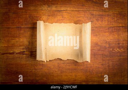 parchment scroll on wooden background. Stock Photo