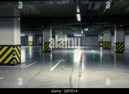 Parking garage, underground interior with a few parked cars. Stock Photo