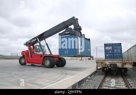 Nairobi, Kenya. 18th May, 2022. A worker unloads a container from a train in Nairobi freight terminal in Nairobi, Kenya, May 18, 2022. TO GO WITH 'Kenya's Standard Gauge Railway enhancing seamless movement of bulk cargo to spur growth' Credit: Long Lei/Xinhua/Alamy Live News Stock Photo