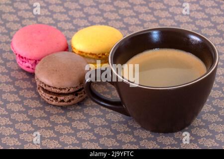 cup of coffee with macaroons on a table Stock Photo