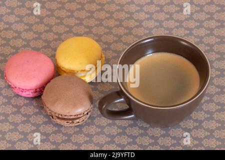 cup of coffee with macaroons on a table Stock Photo