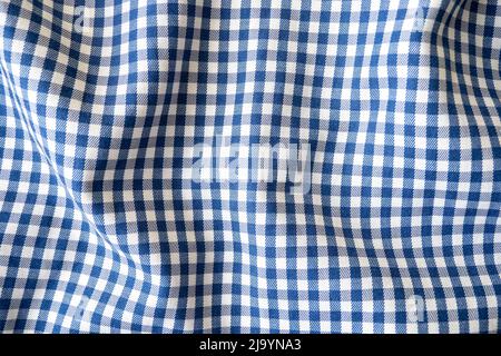 Wavy checkered blue fabric, tablecloth as texture or background, top view Stock Photo