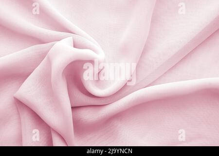 Wavy pink chiffon texture or background, twisted soft transparent chiffon Stock Photo