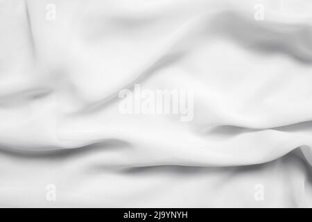 White wavy folded fabric, cloth as texture or background, top view for overlay Stock Photo