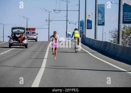 Kazan, Russia - May 17, 2022: female athlete leader run race during Kazan Marathon Stock Photo