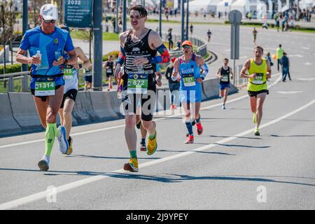 Kazan, Russia - May 17, 2022: group male runners run down street during Kazan Marathon Stock Photo