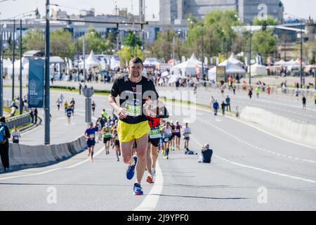 Kazan, Russia - May 17, 2022: male athlete running ahead of group runners during Kazan Marathon Stock Photo