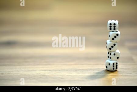 stacked dice on wooden table Stock Photo