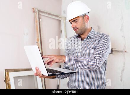 Man engineer managing process with laptop Stock Photo