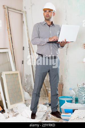 Man engineer managing process with laptop Stock Photo