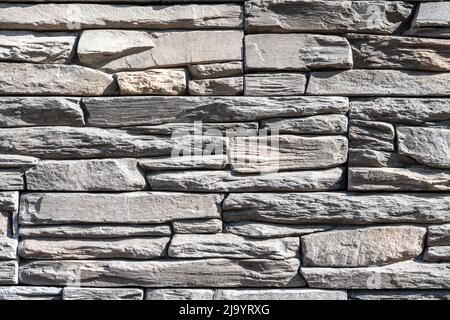 Background from a wall made of old natural gray stone Stock Photo