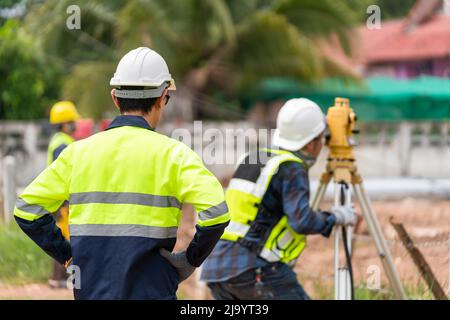 Surveyor Civil Engineer with equipment on the construction site. Stock Photo