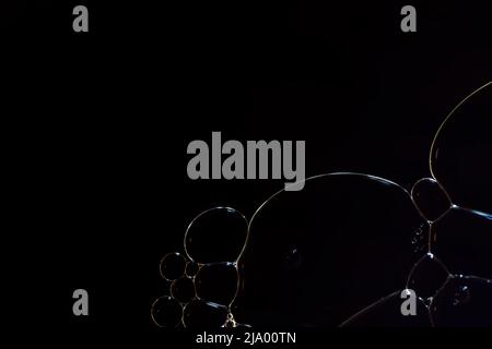 Fantasy abstract black background with ornament made of soft clear bubbles Stock Photo