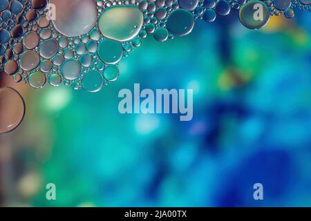 Fantasy colorful blurry background with ornament made of soft clear bubbles, abstract color splashes with copy space, focus on foreground Stock Photo