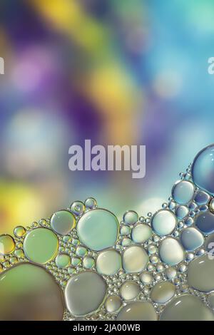 Fantasy colorful blurry background with ornament made of soft clear bubbles, abstract color splashes with copy space, focus on foreground Stock Photo