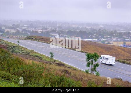 A Winnebago Vista Motor Home on an empty road in the hills above Yucaipa, California USA Stock Photo