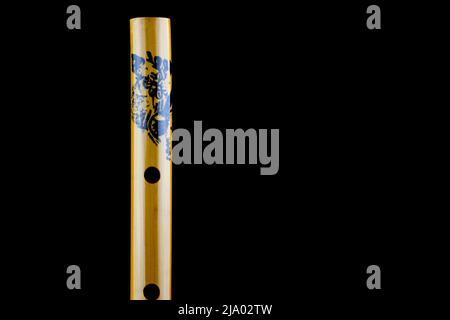 Closeup view of chinese bamboo flute isolated against a black background Stock Photo