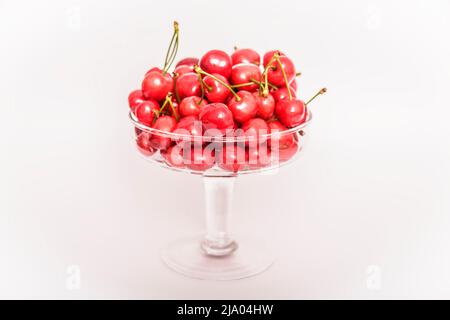 Cherries. Cherry. Cherries in color bowl and kitchen napkin. Red cherry. Fresh cherries. Cherry on white background. healthy food concept. Stock Photo