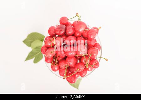 Cherries. Cherry. Cherries in color bowl and kitchen napkin. Red cherry. Fresh cherries. Cherry on white background. healthy food concept. Stock Photo