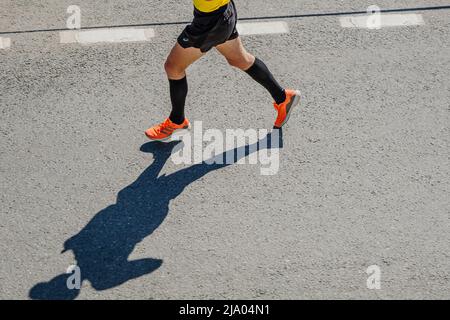 male runner in compression calf sleeve run over rocks Stock Photo - Alamy