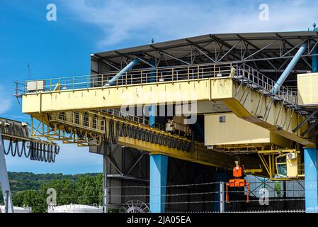 Large stationary gantry with a sliding steel handle for small containers with a lifting capacity of 18.5 tons, located in the hall outside. Stock Photo