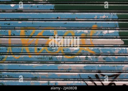 Metal warehouse garage door with horizontal lines. Stock Photo