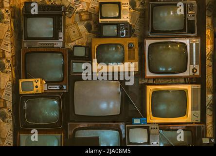 wall of pile colorful retro television. Old TV, vintage style. Stock Photo