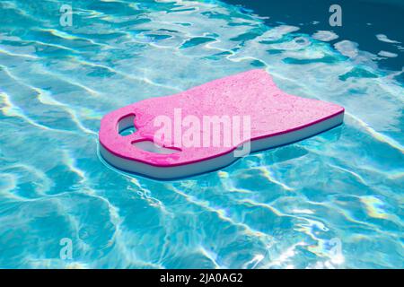 Floating board in the pool for learning to swim. Stock Photo