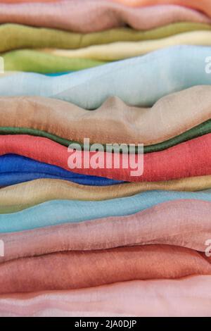 Multi-colored monochromatic silk soft fabrics stacked horizontally Stock Photo