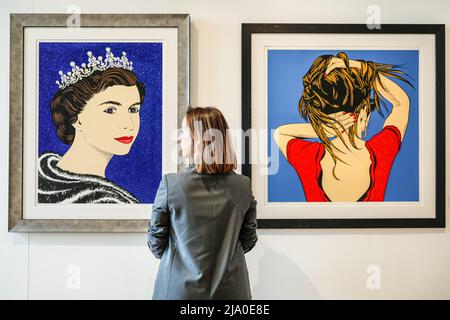 London, UK. 26th May, 2022. A staffer poses with 'Queen' (2022), left, and 'Save the Date', right, (2018) both by Deborah Azzopardi, Cynthia Corbett Gallery. The 37th Edition of the London Original Print Fair opens at Somerset House, running until 29th May 2022 - including works by Picasso, Hockney and exclusive works marking the Queen's Platinum Jubilee. It is the longest running print fair in the world, founded in 1985 at the Royal Academy of Arts. Credit: Imageplotter/Alamy Live News Stock Photo