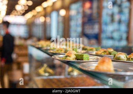 Traditional dessert called 'Baklava' on a gray vintage plate in a restaurant in the city of Gazinatep of Turkey country. Stock Photo