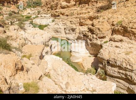 Famous of its vertical cliffs and the green water, Wadi Shab is one of the most beautiful wadi in Oman, and a very popular tourist destination Stock Photo