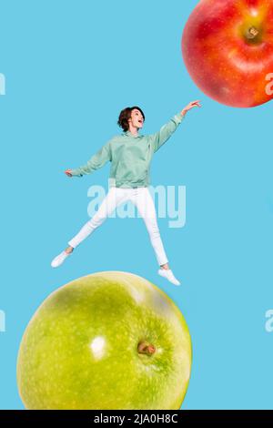 Exclusive dynamic magazine sketch collage of lady jumping touching huge big red green apples isolated blue colorful background Stock Photo