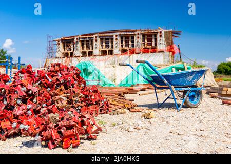 View on heap of disassembled steel scaffolding joint on construction site. Stock Photo