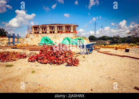 View on heap of disassembled steel scaffolding joint on construction site. Stock Photo