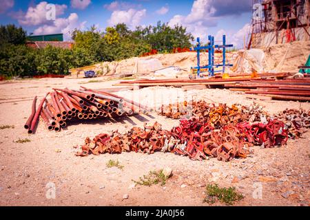 View on heap of disassembled steel scaffolding joint on construction site. Stock Photo