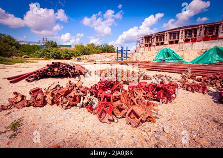 View on heap of disassembled steel scaffolding joint on construction site. Stock Photo