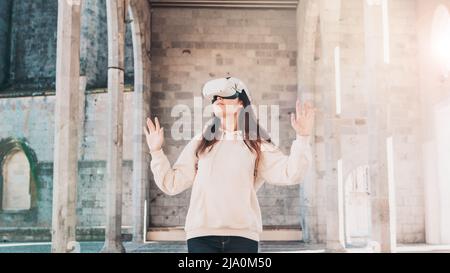 Woman wearing vr headset in european street, virtual travel concept Stock Photo