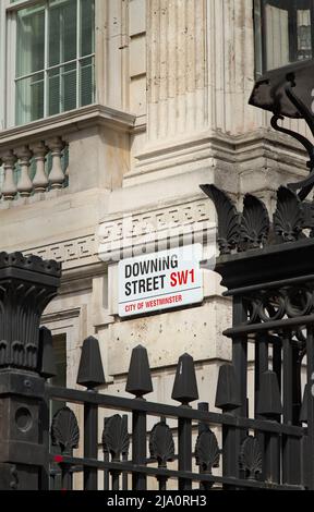Enamelled Downing Street Sign SW1 Seen Through Metal Protective Fence Outside 10 Downing Street London Uk Stock Photo