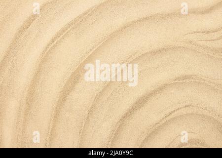 Yellow wavy sea sandy beach. Concept of summer, vacation, holiday background. Copy space Stock Photo