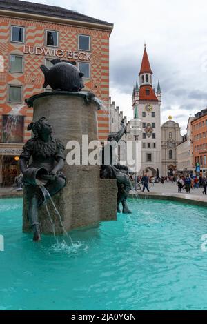 Munich, Germany - 04.07.2022: fischbrunnen in Marienplatz Munich with people and the altes Rathaus Stock Photo